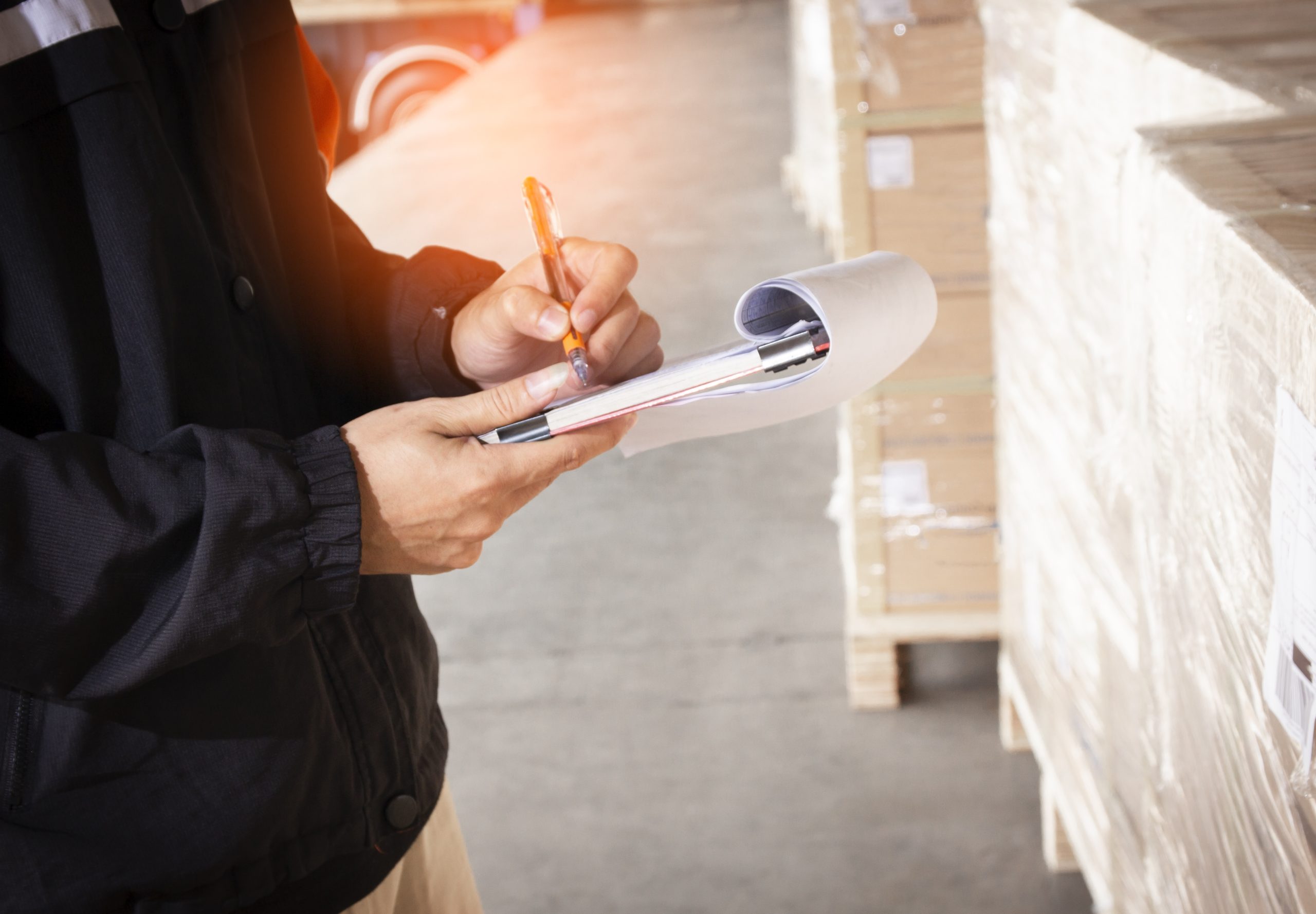 warehouse-staff-are-holding-clipboard-with-inventory-shipment-pallet